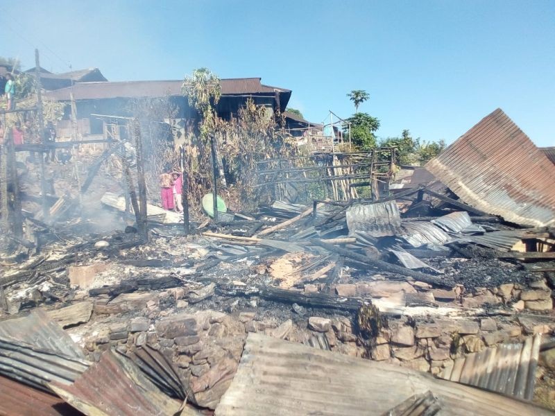 Villagers look on at the remnants of a house that was razed in a fire in Wakching village on November 8. (Morung Photo)
